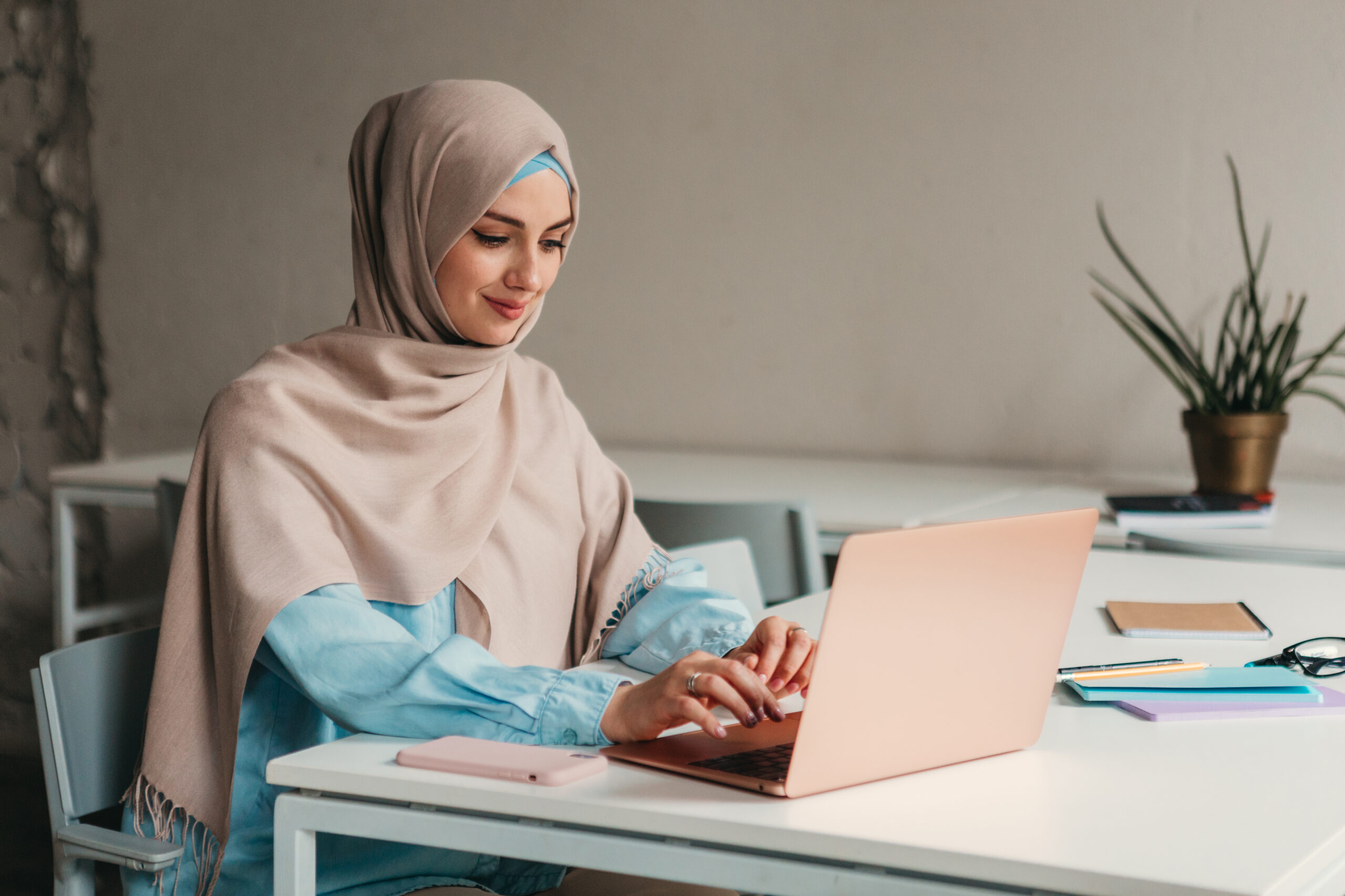 modern muslim woman in hijab in office room